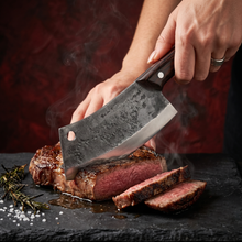 Kermode hand forged chef cleaver with a steak on a cutting board