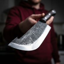 Kraken 8 inch hand forged cleaver shown with steak, hammer textured high carbon steel